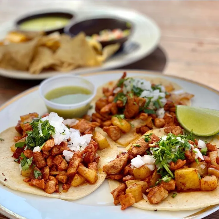 Al pastor tacos topped with pineapple