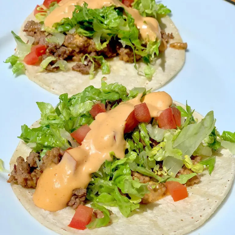Cheeseburger taco sizzling on the griddle